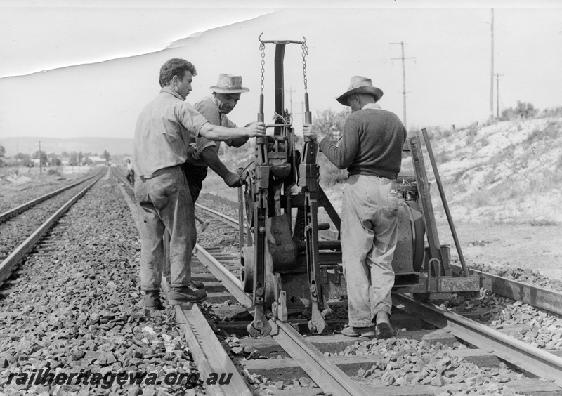 P10387
Track gang using dog spike puller. Location Unknown.
