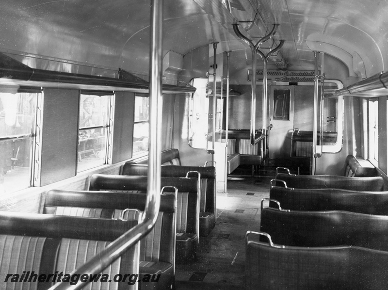 P10391
Interior view of a suburban railcar trailer showing crush barriers and luggage racks. Location Unknown.
