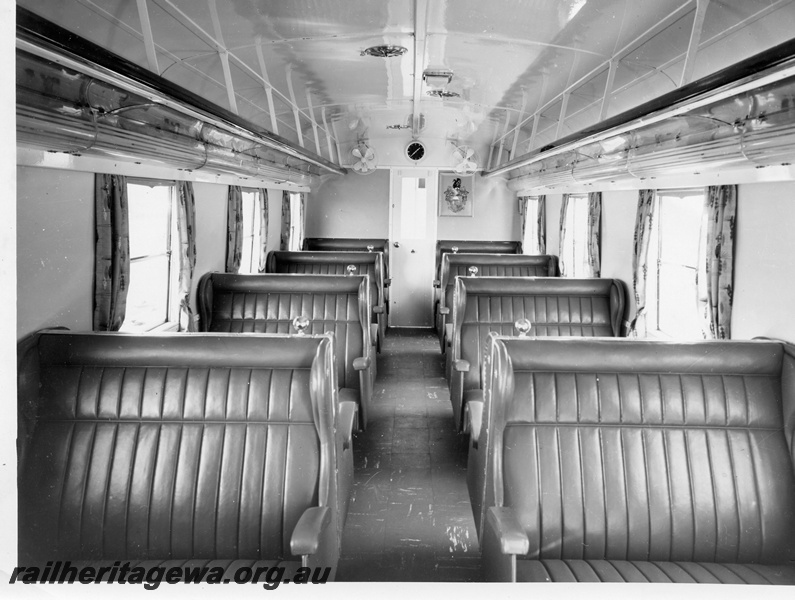 P10398
AYU class trailer car showing window curtains, saloon fans, overhead luggage racks and Bunbury coat of arms. Opposite end to refreshment vending machines. See P10394.
