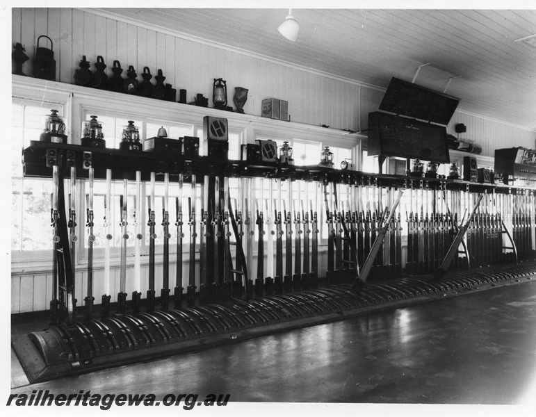 P10401
East Perth Signal Box, interior view, showing signal levers and signal diagram. CTC Panel for Goodwood - Rivervale at far right. Signalling instruments mounted on shelf above lever frame. 
