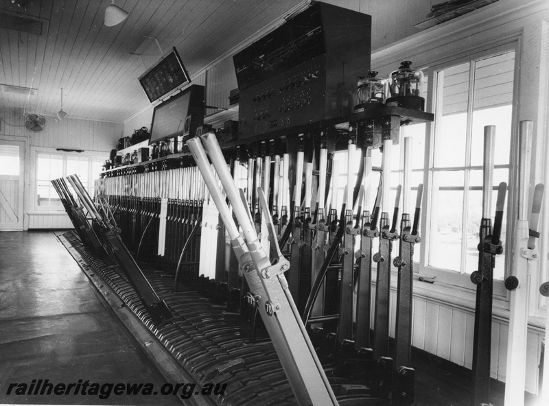 P10402
East Perth Signal Box, interior view, showing signal levers and signal diagram. CTC Panel for Goodwood - Rivervale at far right. Signalling instruments mounted on shelf above lever frame. 
