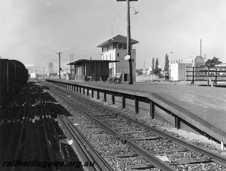P10410
Rivervale Station, now Burswood, pictured in 1967 with new station building under construction. signal box is highlight as is outdoor toilet. Suburban goods train in shunting loop.
