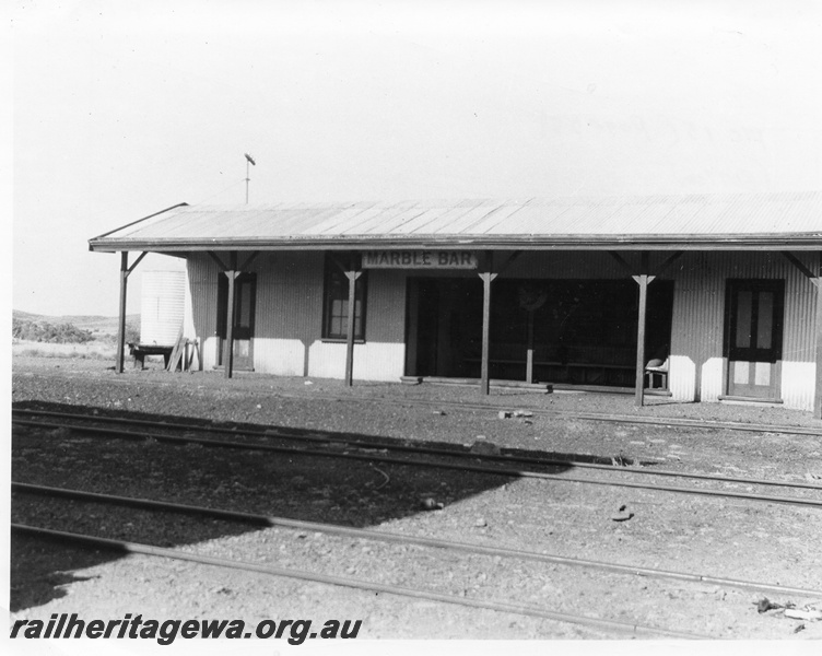 P10435
Station building, trackside view, nameboard, tracks, Marble Bar, PM line. 
