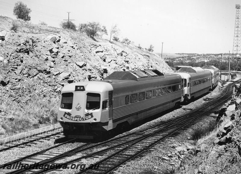 P10448
Prospector 3 car set entering the eastern end of Avon Yard on a V.I.P. Special service to Perth. Side and end view of rear car, yard light tower to right, narrow gauge trackage in foreground. Avon Valley line
