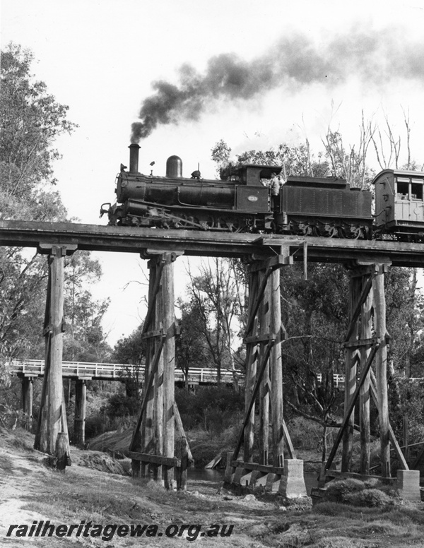 P10461
G class 233 steam locomotive hauling the Vintage Train over the Preston River bridge at Boyanup. Side view of locomotive and road bridge in background. BB line.
