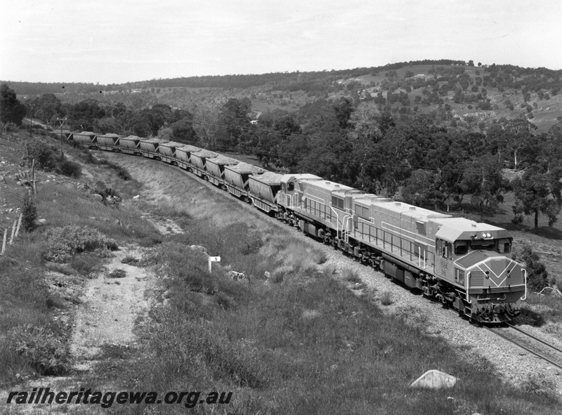 P10462
DB class locomotives hauling a loaded bauxite train down the Darling escarpment between Jarrahdale and Mundijong. Front view of lead locomotive and overhead view of both locomotives.
