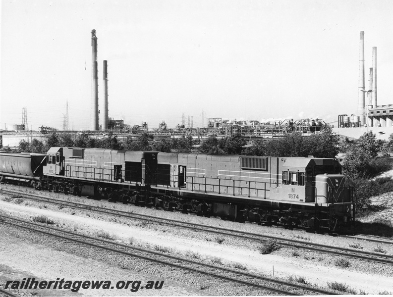 P10470
2 of 6. N class 1874 and 1873 diesel locomotives unloading bauxite at Kwinana. The towers at left are the BP Refinery and on the right are part of Alcoa's plant.

