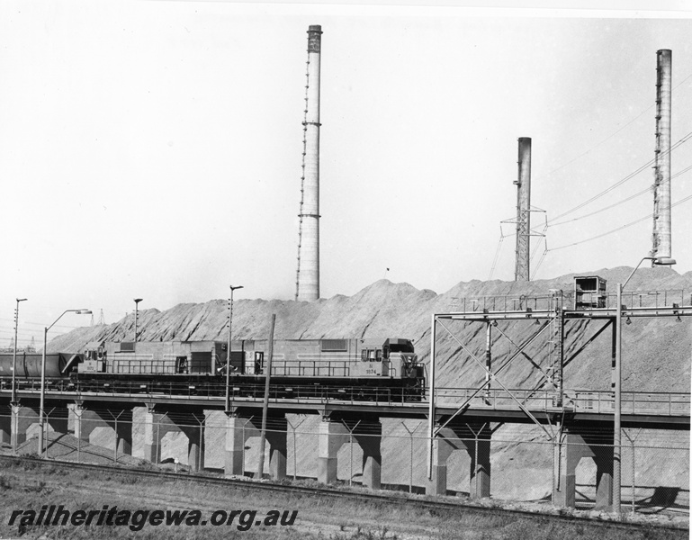 P10472
4 of 6. N class 1874 and 1873 diesel locomotives proceeding onto the unloading bridge at Alcoa's Kwinana plant with towers in the background.
