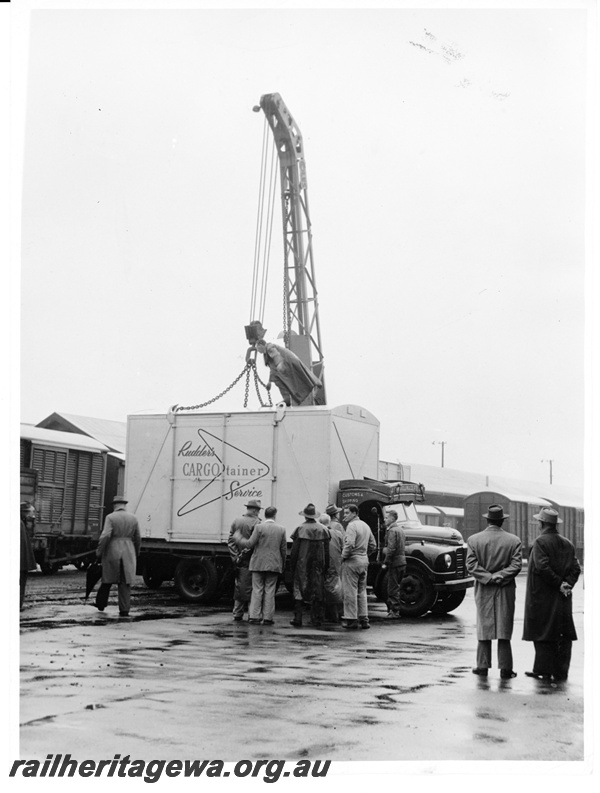 P10546
A Rudders Container being unloaded from a road truck at the former Perth Goods Yard on a wet day and interested bystanders taking note.
