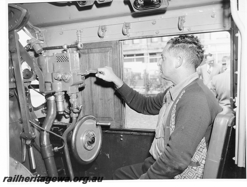 P10549
A steam driver at the controls of a V class steam locomotive. The locomotive was on display at the 'Rose Garden' at Perth Station.
