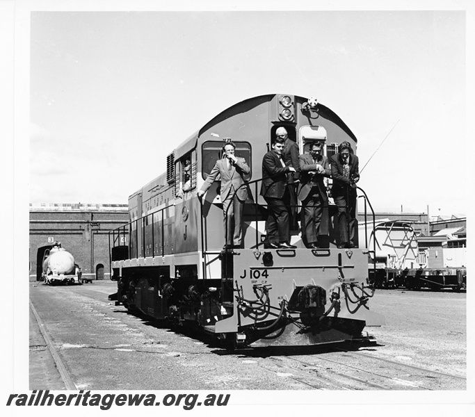 P10552
Mechanical Staff personnel on the front running board of standard gauge diesel locomotive J class 104 after overhaul at Midland Workshops. See also P13713 and P13714. 
