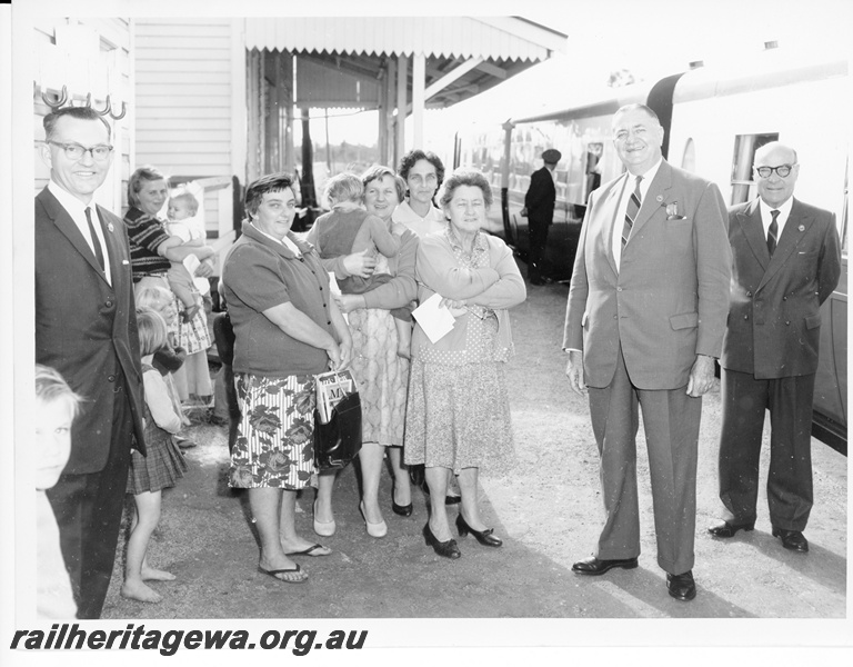 P10583
Commissioner of Railways, Mr. C. G. C. Wayne, together with the Commercial Manager, Mr B W E Copley, meeting with local people with the 'Bunbury Belle' train in the background. See P.
