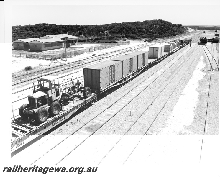 P10587
An overhead view of the standard gauge yard at Esperance showing wagons loaded with containers and a grader.
