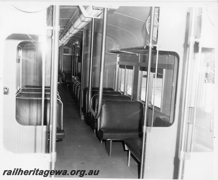 P10616
Interior view of an ADK suburban railcar. Leather seats, luggage racks and stainless steel grab rails.
