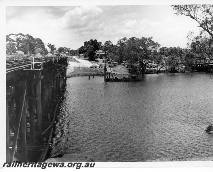 P10660
Wooden trestle rail bridge, Swan River, pontoon and machinery at construction site of new standard gauge bridge, Guildford, ER line
