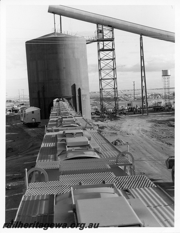 P10700
An overhead view of mineral sands wagons, showing roof details, at the Eneabba loading point. Z class brakevan on the run round road waiting to be placed at end of train.
