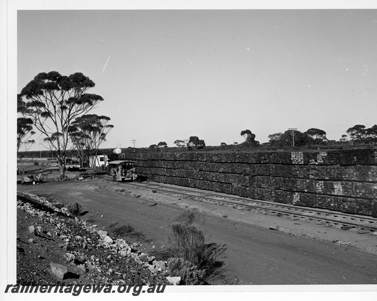 P10859
Sleeper yard, large plies of wooden sleepers, small rail vehicle, rural setting, view from elevated position
