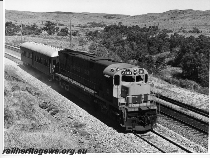 P10898
Hamersley Iron (HI) C628 class 2004 hauling communications train (ex NSWGR passenger carriage FS class 2010) at Emu.
