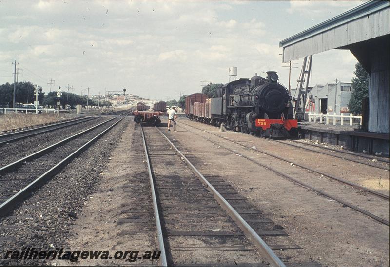 P11356
PMR class 735, up goods, crossing lights, signals, industrial water tank, industrial buildings, crane, loading bank, part of goods shed, level crossing activation switches, Maylands. ER line.
