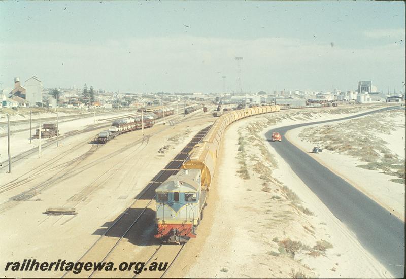 P11403
Leighton yard, overall view, car carriers in yard, J class 103 on wheat wagons. ER line.
