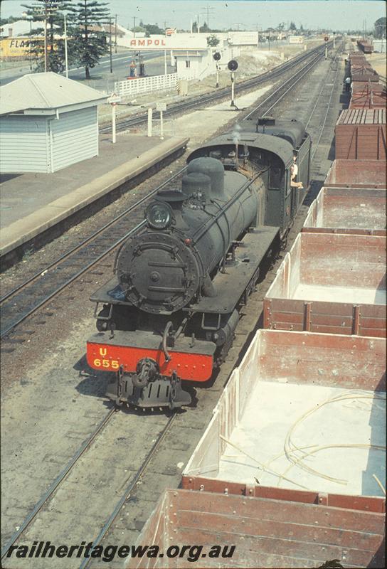 P11412
Bassendean, overall view, west end, part of platform and sheds, signals, U class 655 running around train. ER line. Elevated internal view of open wagons with superphosphate residue
