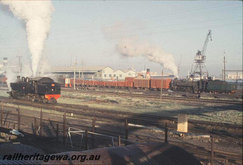 P11630
DD class 593, B class shunter, PMR class 731 tender first on down goods, harbour in background, Fremantle. ER line.
