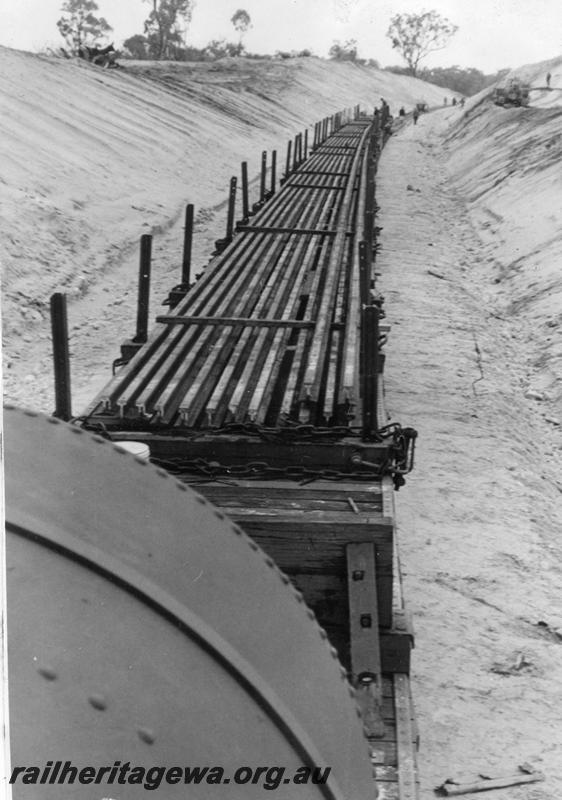 P12028
6 of 12 images of the construction of the Kwinana to Jarrahdale railway. (ref: The Railway Institute Magazine, July 1963).view shows rail being delivered to the railhead.
