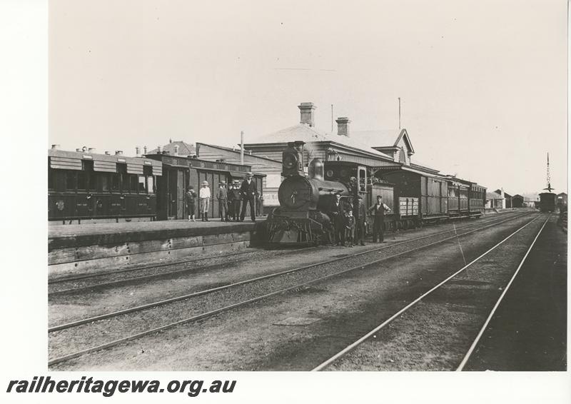 P12052
A class 2-6-0 steam loco with mixed train, station building, Geraldton, NR line, MRWA carriage and brakevan in the dock platform, c1900, (scanned print located in MC1B2G)
