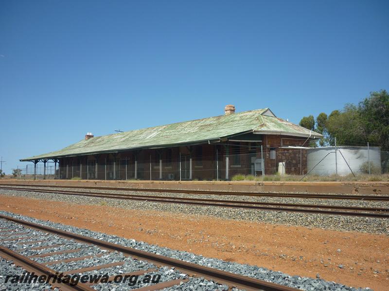 P12054
2 of 9 views of the station building at Menzies, KL line, disused and fenced off to the public, north end and trackside view.
