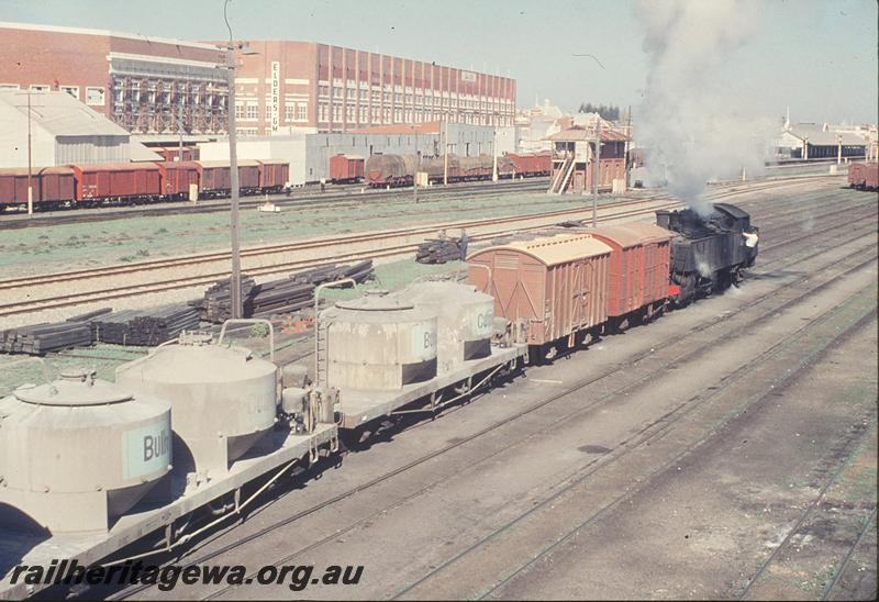 P12172
DD class 595, arriving Fremantle yard, bulk cement wagons, Box B, platform in background. ER line.
