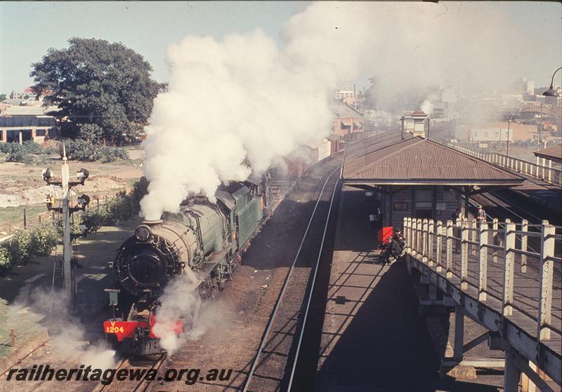 P12199
V class 1204, 37 goods departing East Perth, station buildings, platform. SWR line.
