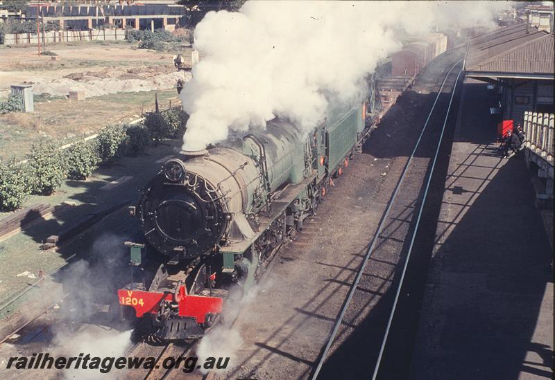 P12200
V class 1204, 37 goods departing East Perth, station buildings, platform. SWR line.
