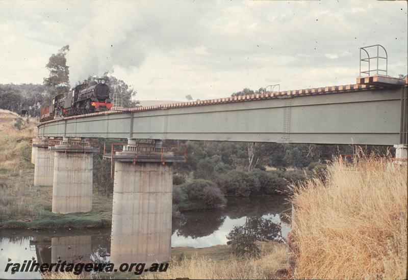 P12419
W class 937, W class 917, ballast train on steel girder bridge, Bridgetown, PP line. Additional wagons including stock wagon for brake power.
