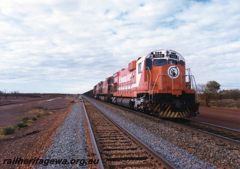 P12543
Port Hedland - Newman railway, BHP line, Alco M636 class 5464 wearing the new Mount Newman Mining livery, 2 similar units in the original livery are behind it, loaded train on mainline
