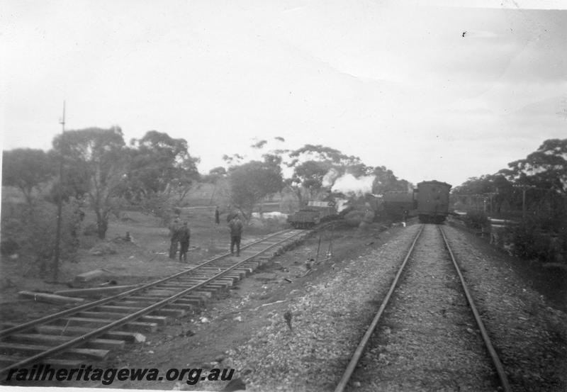 P12638
1 of 3 views of the derailment of No.4 Passenger 1.5 miles north of Wannamal, MR line. The derailment occurred on the 27th July, 1946 due to a washout at a culvert, view along the track showing the temporary track
