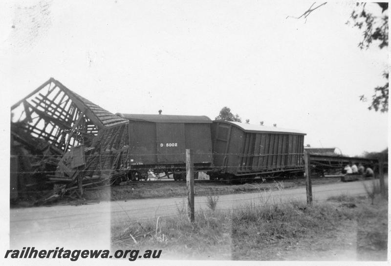 P12642
2 of 4 views of the head on collision of two trains at Gingin, MR line, view shows a wrecked SX class 10229 sheep van, WAGR D class 5002 van with a corrugated iron roof with a single torpedo ventilator, MRWA LC class bogie van
