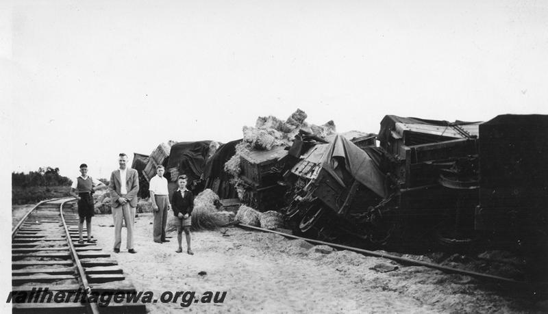 P12659
I of 3 views of the derailment at Muchea, MR line, row of derailed wagons
