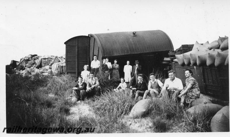 P12661
3 of 3 views of the derailment at Muchea, MR line, row of derailed wagons, views shows a family picnic alongside a row of derailed wagons
