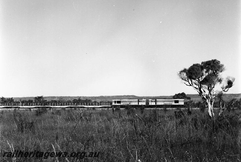P12704
K classes double heading with a train of flat wagons, side on distant photo of the train.
