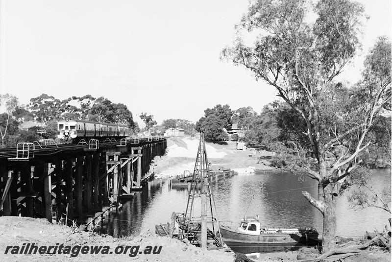 P12735
ADG class on three car railcar set, crossing the trestle bridge at Guildford, preliminary work on the standard gauge rail bridge in view.
