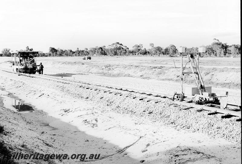 P12768
Track construction on the standard gauge, track tamper on newly ballasted track
