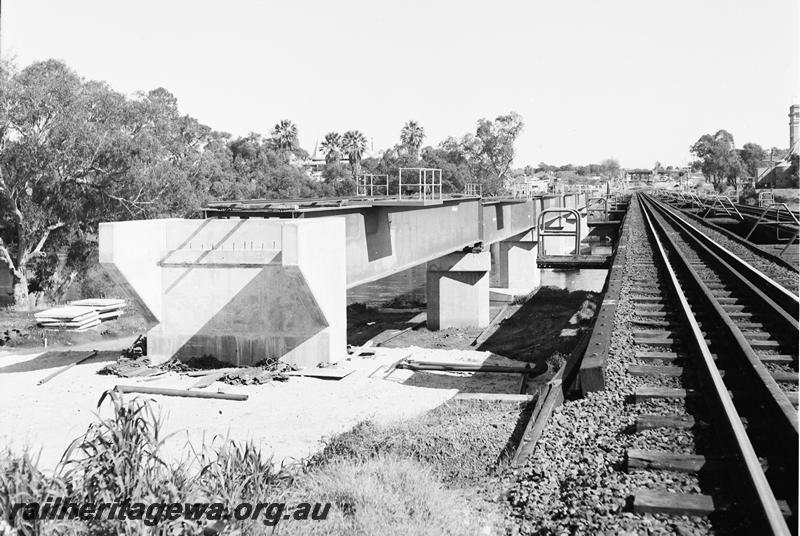 P12770
Steel girder bridge over the Swan River at Guildford, under construction, wooden trestle bridge in the view, looking towards Perth. 
