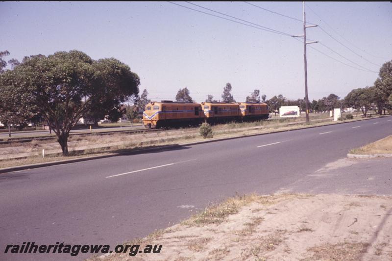 P12785
Three X class locos coupled together with a white tail disc on the rear loco, Bassendean passing the Rail Transport Museum for Royal Show workings
