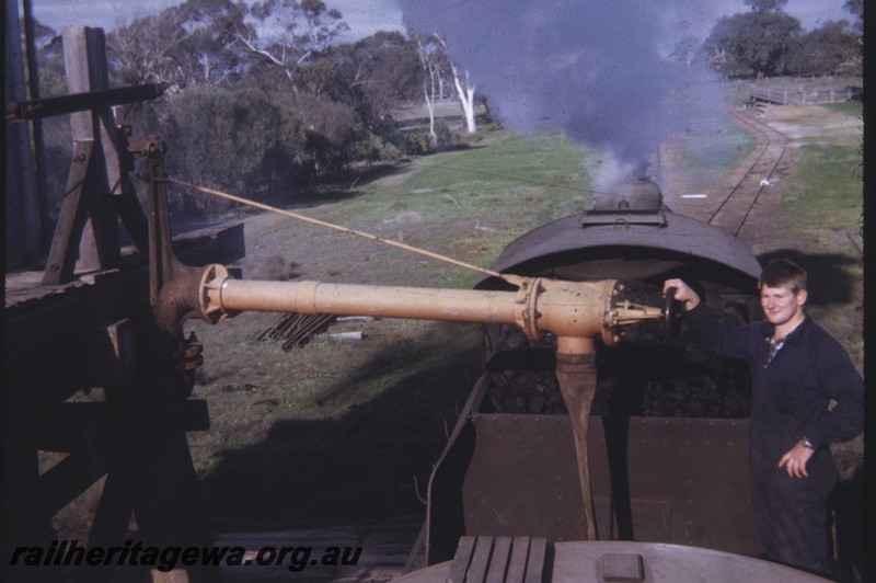 P12836
W class, tank mounted water column, Noockanellup, DK line, view looking forward over the tender, Brian Henderson controlling the water. 
