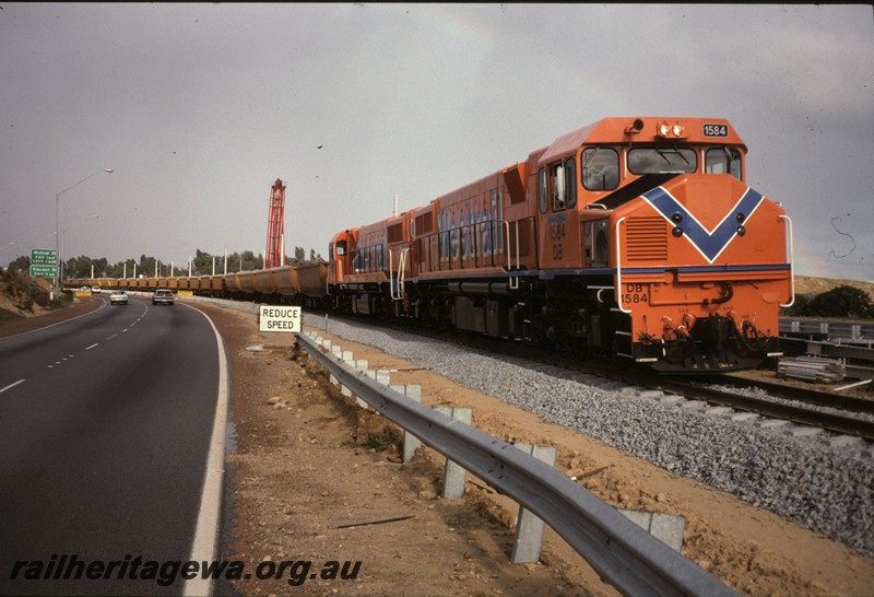 P12881
DB class 15 84 double heading with another DB class with a ballast train on the Northern Suburbs Railway under construction.
