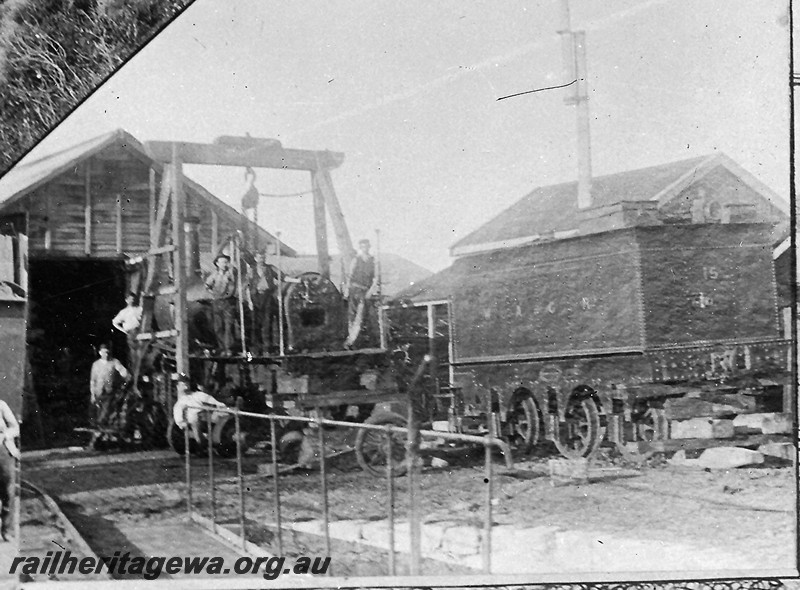 P12913
A class 15, undergoing repairs at the Geraldton Loco Depot, the loco has its cab removed and the tender is separated from the loco. The image has been extracted from the Geraldton Loco Depot Christmas Card/poster from 1897.
