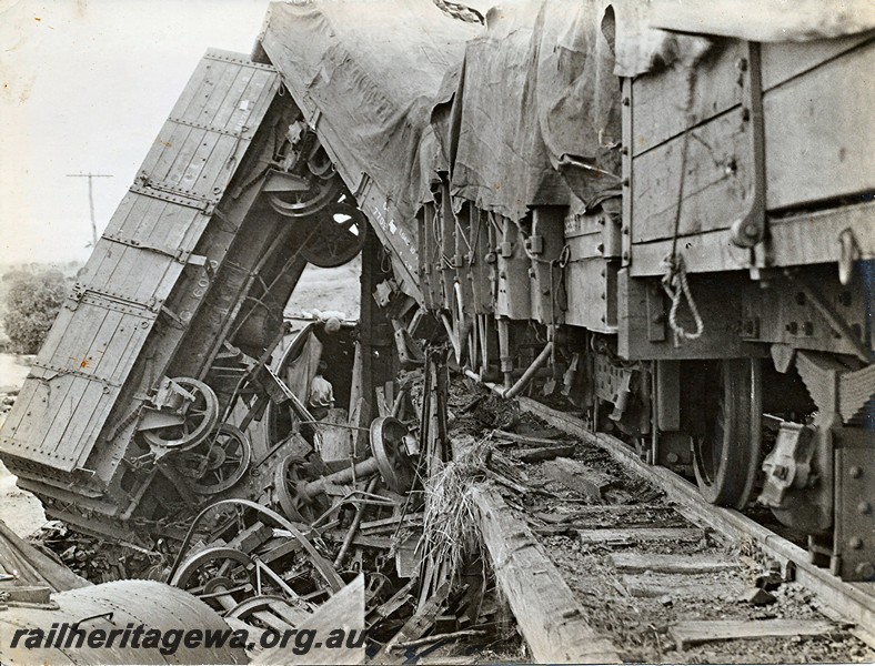 P12925
4 of 8 images of a derailment at Dumberning, BN line, derailed wagons including GA class 6070 suspended almost vertically off the track. Date of derailment 14/3/1934
