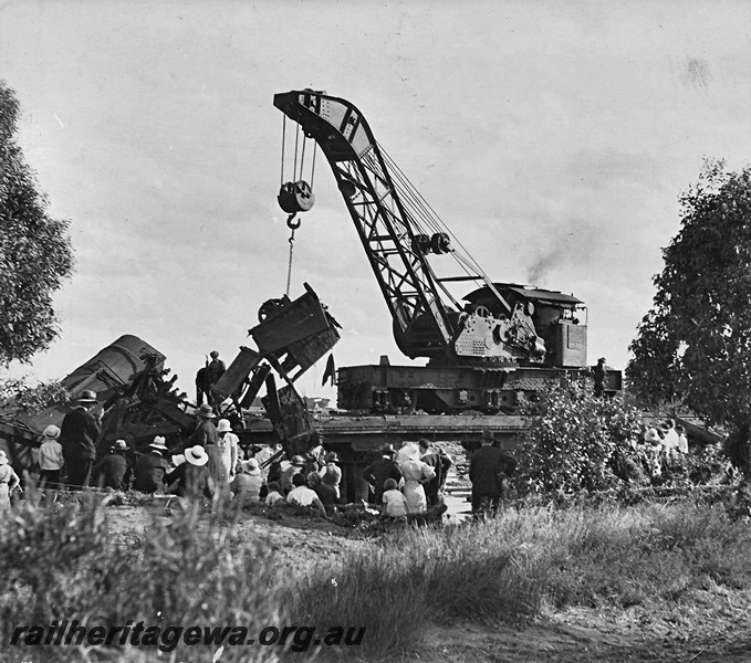 P12927
6 of 8 images of a derailment at Dumberning, BN line, steam breakdown crane No.23 lifting a smashed wagon clear of the track, many onlookers who appear to be dressed in their 