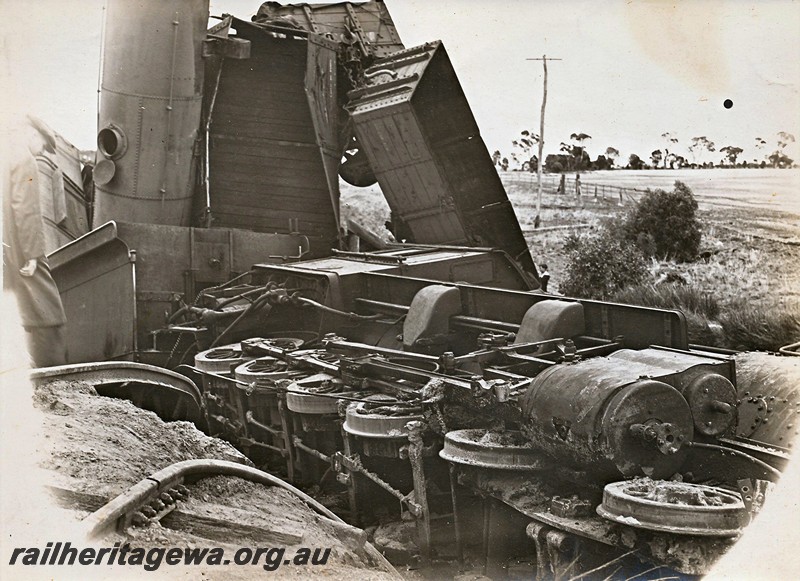P12928
7 of 8 images of a derailment at Dumberning, BN line, the F class lying on its side showing its underside at right angles to its tender. Date of derailment 14/3/1934
