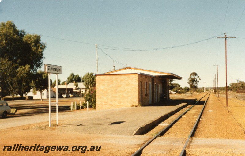 P12952
Station nameboard, station building, telegraph poles, Perenjori, EM line, side and trackside view 
